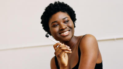 woman holding charcoal toothbrush